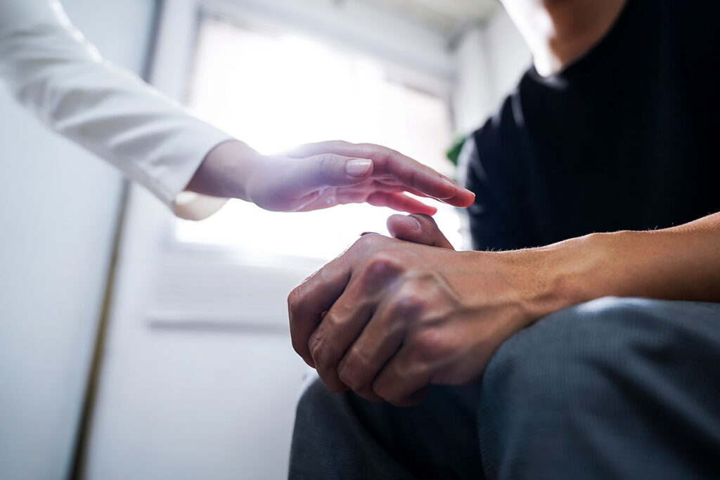 doctor reaching out to patient